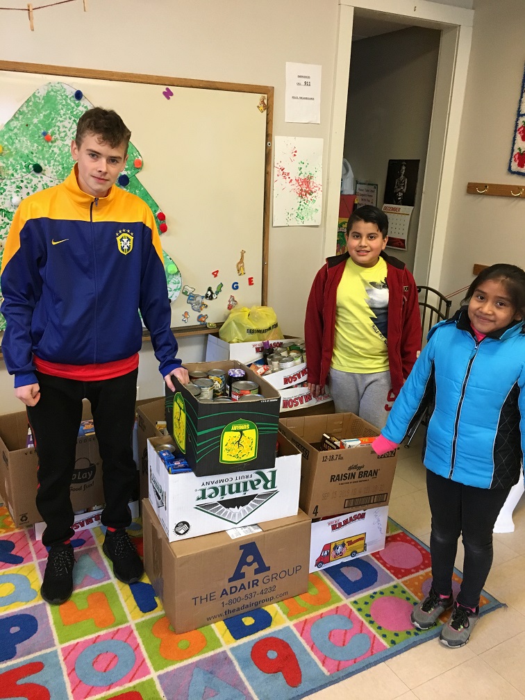 student helpers with boxes of food drive donations delivered on Dec 7