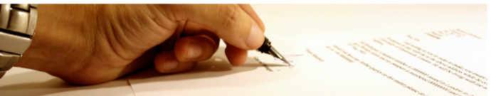 hand wearing watch filling out paperwork with a pen.